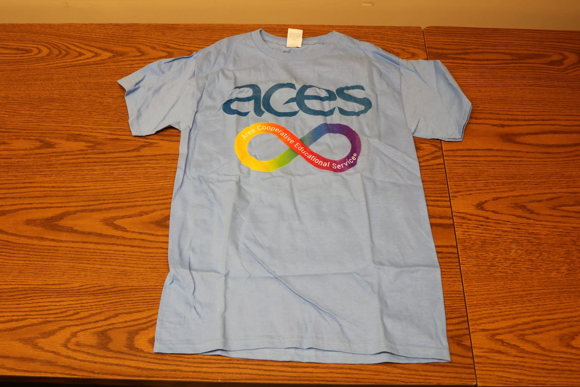 Autism Speaks Tshirt with ACES logo and rainbow infinity symbol